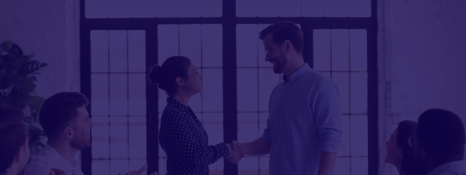 Two people shaking hands to mark a brand payments partnership
